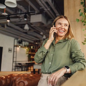 Lady smiles while talking on phone