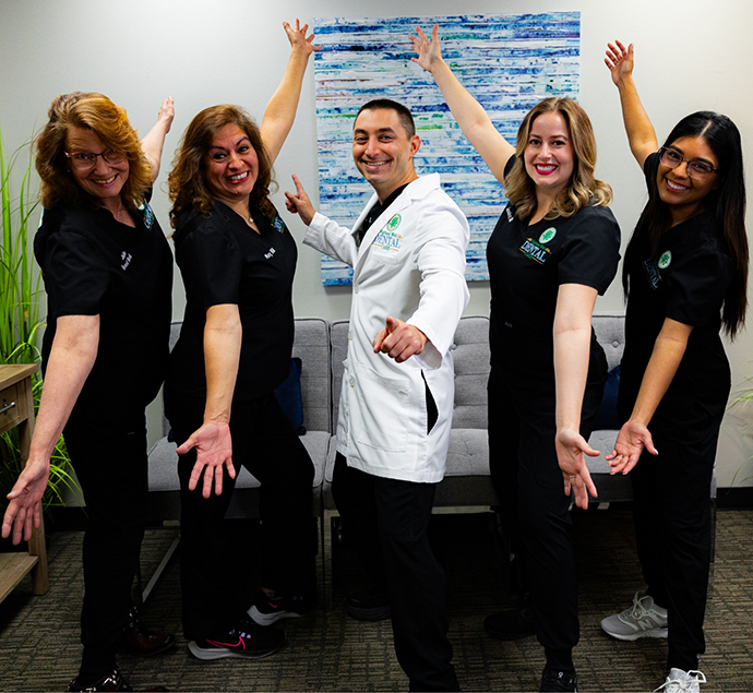Highland West Dental Care team smiling in the reception area of the dental office