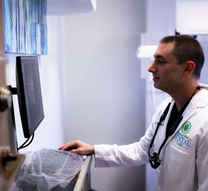Doctor Pevzner looking at x rays of teeth on a computer