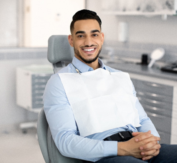Patient smiling while sitting in treatment chair