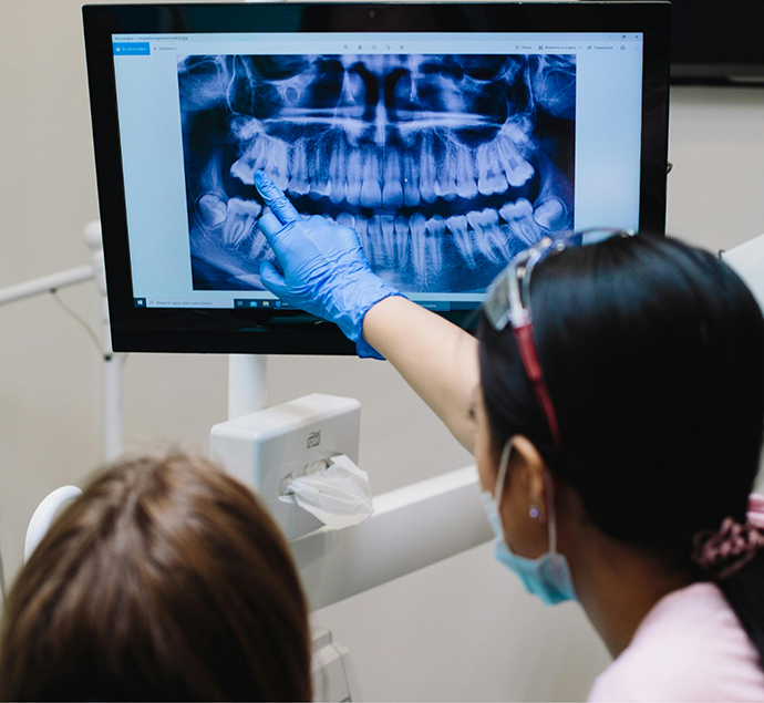 Dentist showing a patient an x ray of their teeth