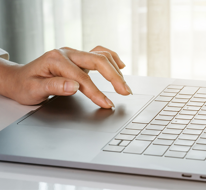 Person using a track pad on a laptop