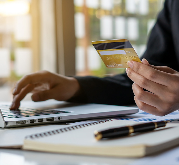 Person entering their credit card information onto their laptop