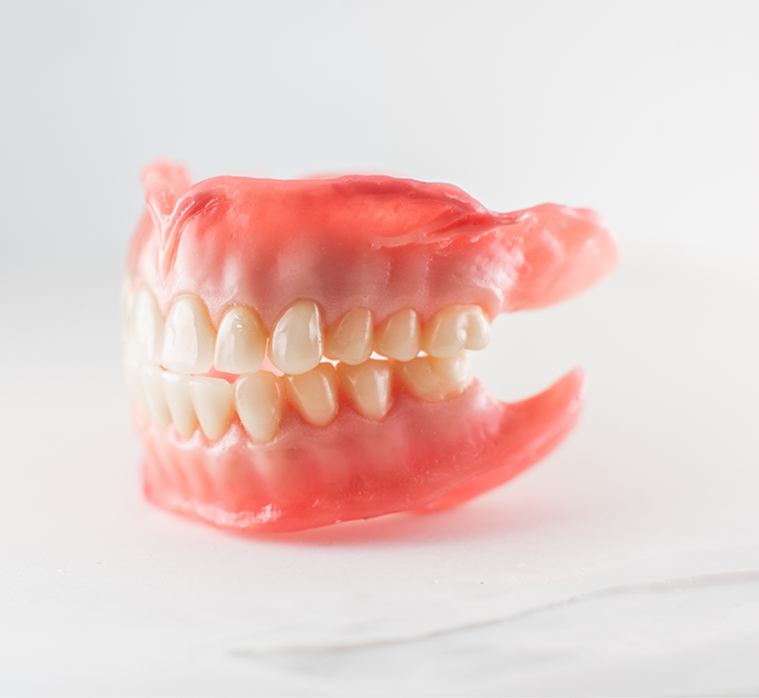 Set of full dentures against a white background