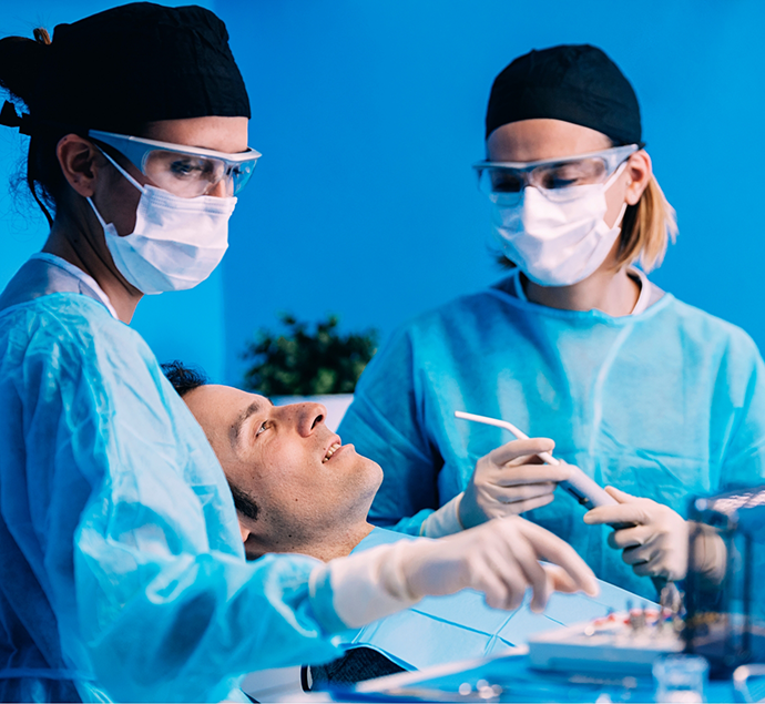 Dentist and assistant treating a patient