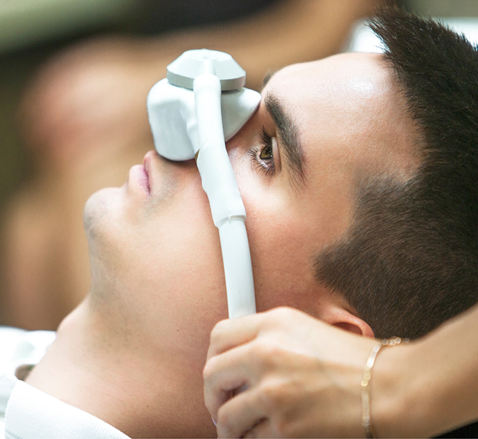 Man with a mask over his nose for nitrous oxide sedation dentistry in Austin