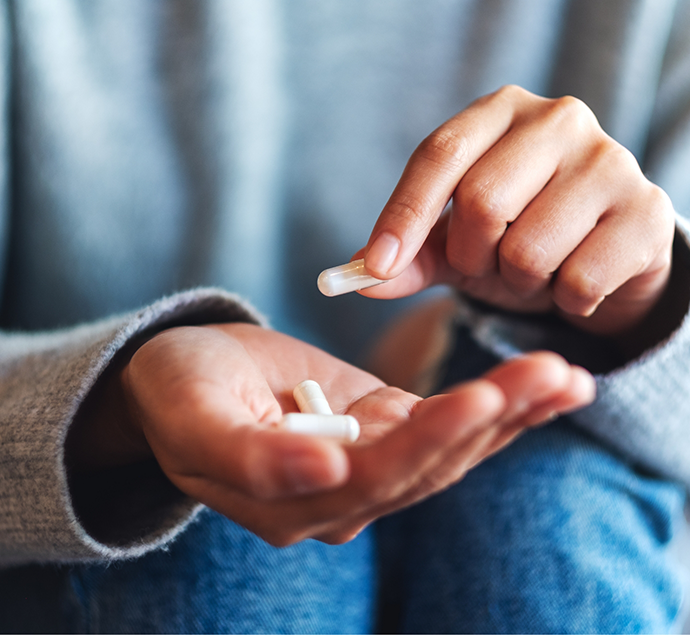 Person holding a white pill