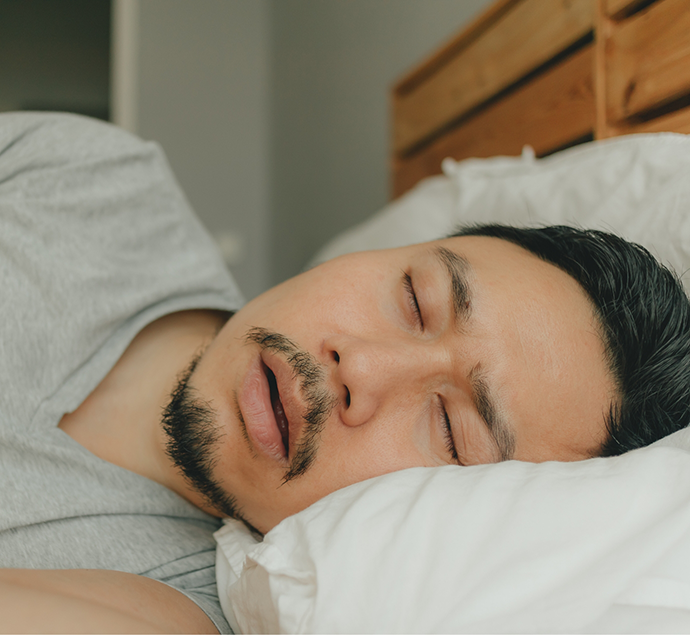 Man sleeping on his side with his mouth open before sleep apnea treatment in Austin
