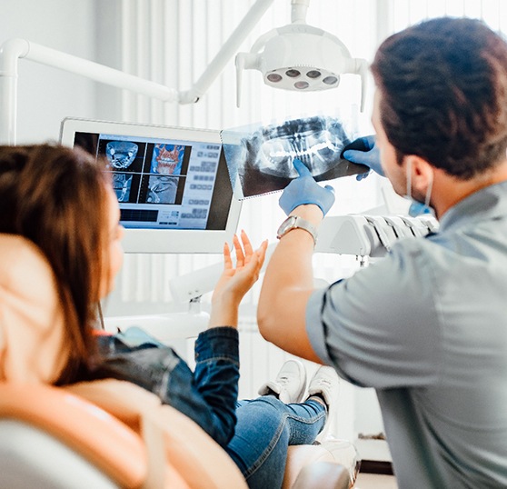 Dentist and patient reviewing X-ray together