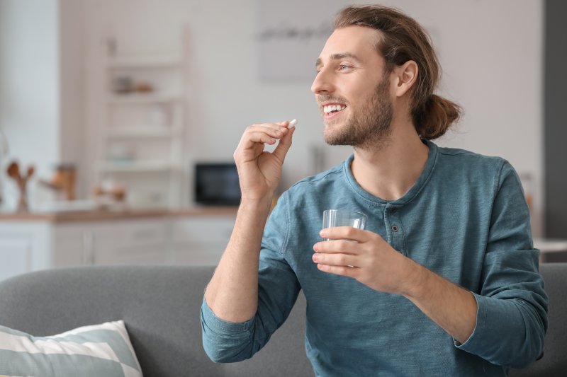 Patient smiling as they take their oral conscious sedation pill
